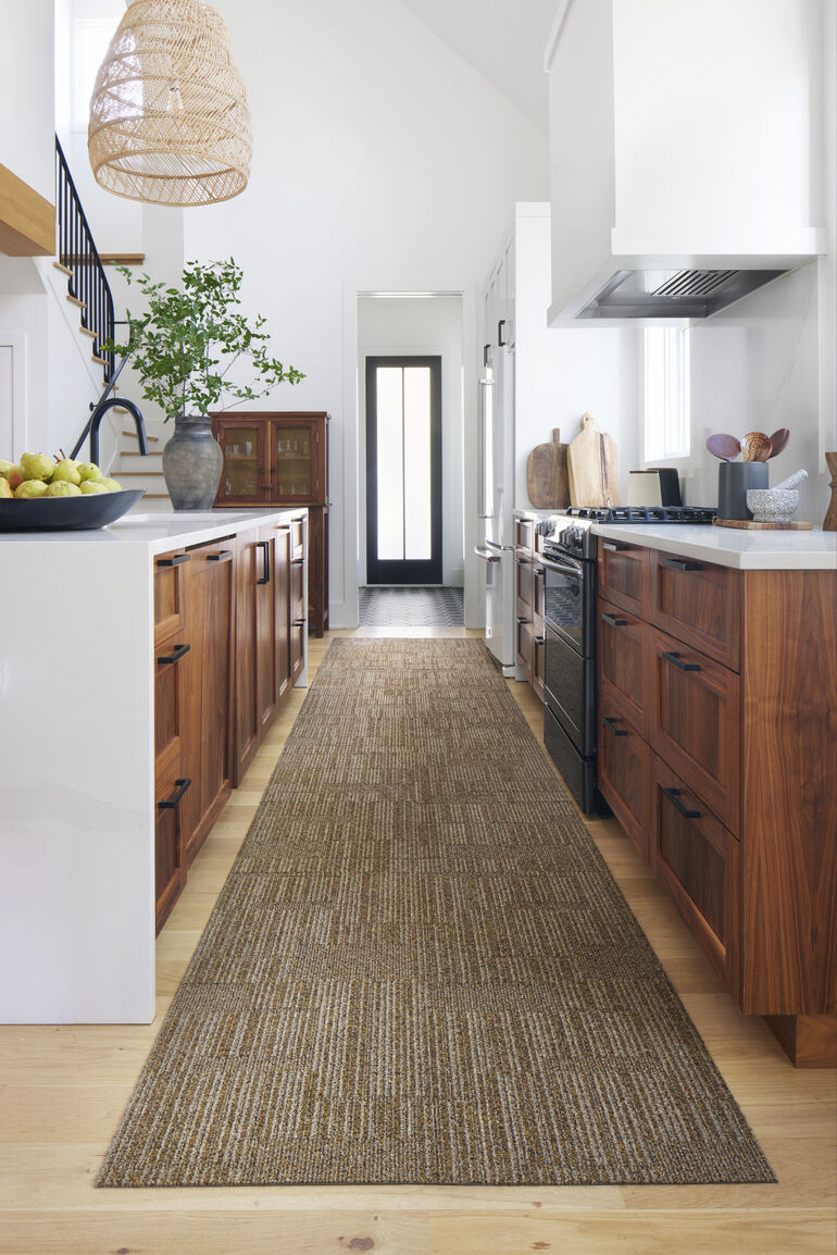 Kitchen aisle with FLOR Morning Coffee runner rug shown in Mocha